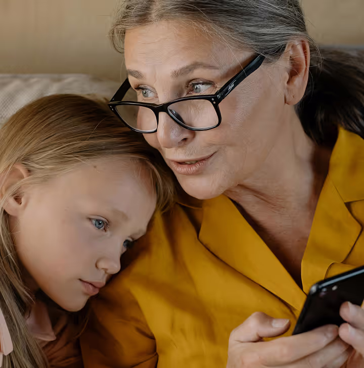 Mother and daughter looking at phone together